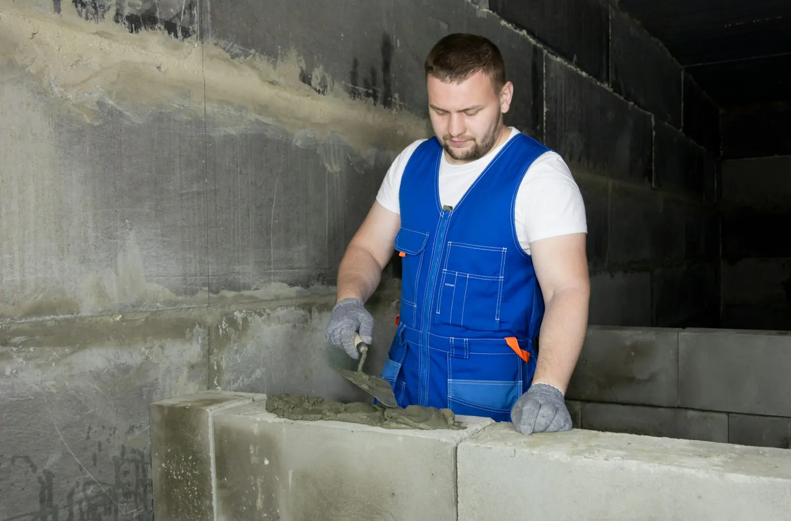 Майстер мурує стіну з газоблоку на клей